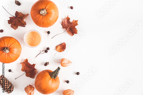 Autumn composition. Pumpkins, candles, dried leaves on white background. Autumn, fall, halloween concept. Flat lay, top view, copy space