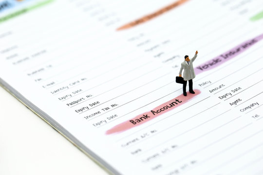 Miniature people : businessman standing with list of Credit Card,concept for Business,tax,money