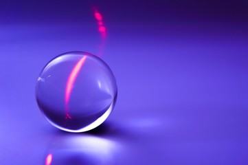 Glass ball in abstract purple