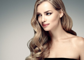 Beautiful woman with long curly blonde hair perfect hairstyle beauty female portrait face