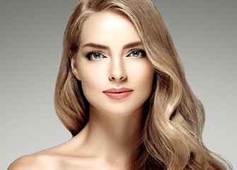 Beautiful woman with long curly blonde hair perfect hairstyle beauty female portrait face