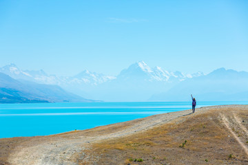 Fototapeta na wymiar Summertime, Asian woman enjoy travel at lake pukaki as a Mt. Cook Background , South island New Zealand