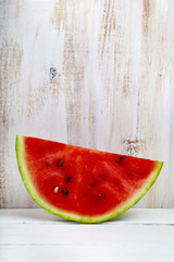 Fototapeta na wymiar Piece of watermelon on a wooden table