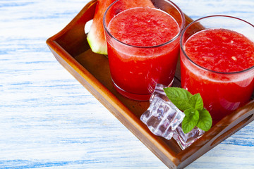 Watermelon juice and mint on a tray