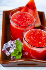 Watermelon juice and mint on a tray