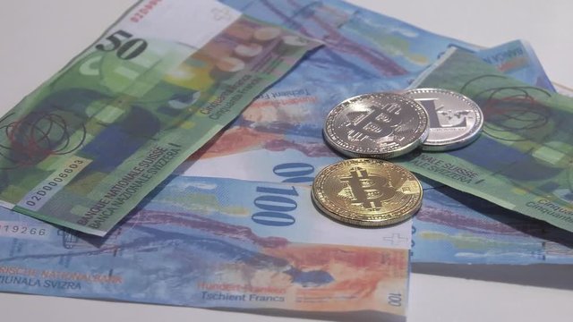 Physical metal Bitcoin currency over bolivar bills. Virtual internet money with Venezuelan banknotes. Digital coin cyberspace, cryptocurrency. BTC golden coin as symbol of electronic virtual money. 4K