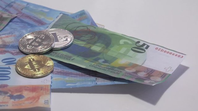 Physical metal Bitcoin currency over bolivar bills. Virtual internet money with Venezuelan banknotes. Digital coin cyberspace, cryptocurrency. BTC golden coin as symbol of electronic virtual money. 4K