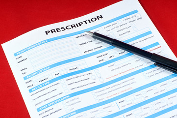 Obraz premium prescription and pen on red velvet background