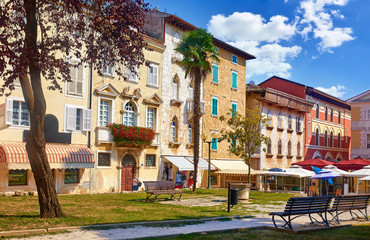Porec, Croatia. Antique decorative houses in old town. Cosy park