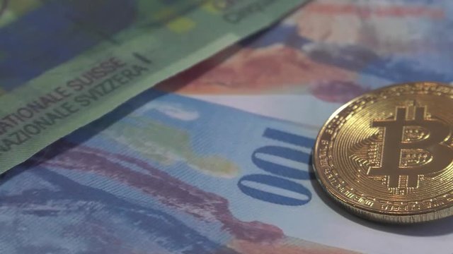 Physical metal Bitcoin currency over bolivar bills. Virtual internet money with Venezuelan banknotes. Digital coin cyberspace, cryptocurrency. BTC golden coin as symbol of electronic virtual money. 4K