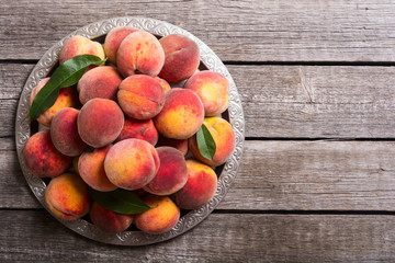 Naklejka na ściany i meble Ripe peaches fruit on rustic background
