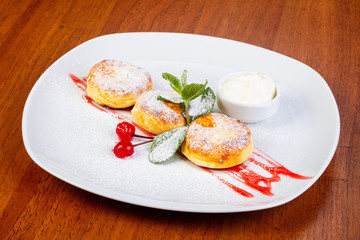 Delicious syrniki with cream