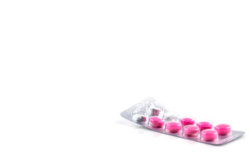 pink pills in package isolated on white