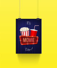 Vector poster hanging on paper clips with pop corn basket, cola cup and movie sign on blue curtain background. It's movie time banner template. 