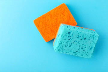 Sponges for dishwashing. Kitchen equipment. Blue background