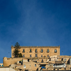 Fototapeta na wymiar Ancient noble palace against the blue sky. Leonforte, Enna, Sicily, Italy.