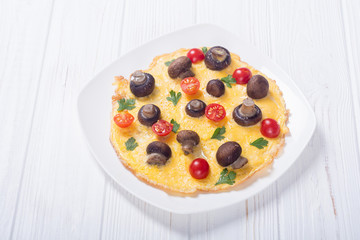Omelette with mushroom , tomato and parsley