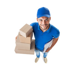 Funny courier with boxes looking at camera isolated on white background