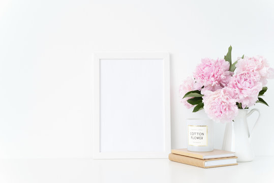 Elegant white blank frame mockup. Still life composition, summer bouquet of pink peonies in vase. Background, mock up for quote, promotion, lettering, lifestyle bloggers and social media
