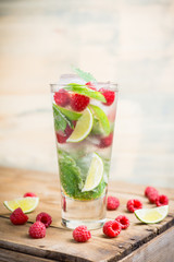 Raspberry mojito cocktail on the wooden background. Selective focus. Shallow depth of field.