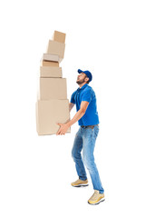 Young delivery man with falling stack of boxes