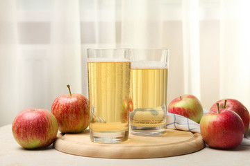 Apple cider in a glass on the window background.