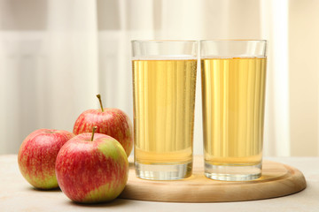 Apple cider in a glass on the window background.