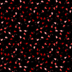 Elegant black seamless pattern with chaotic sparks in different shades of red and pink