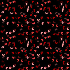 Elegant black seamless pattern with chaotic sparks in different shades of red and pink