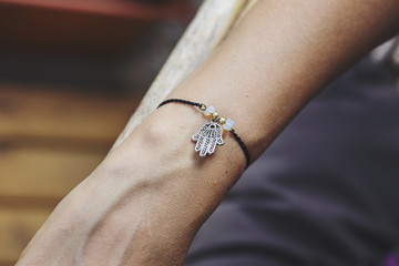 Female hand wrist resting with tiny jewelry