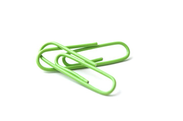 closeup of green paperclips on white background