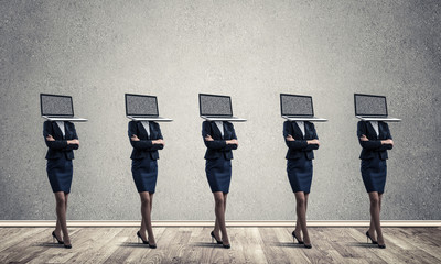 Business women with laptops instead of head.