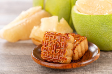 fresh and peeled pomelo(shaddock), grapefruit with slices and mooncake in mid-autumn festival(moon festival)