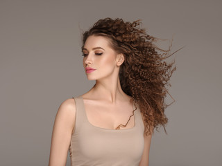 Beautiful hair long curly hairstyle woman with beauty makeup female model portrait