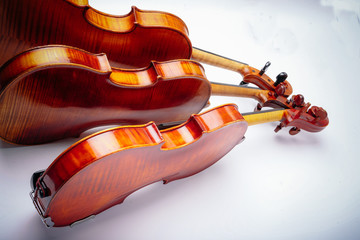 Three violins on a wihte background