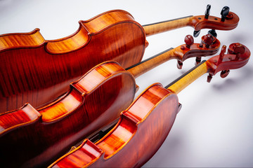 Three violins on a wihte background