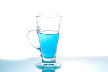 Water splashing into glass of water on white