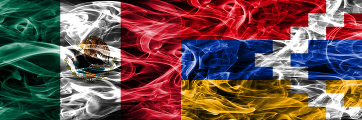 Fototapeta premium Mexico vs Artsakh smoke flags placed side by side. Mexican and Artsakh flag together