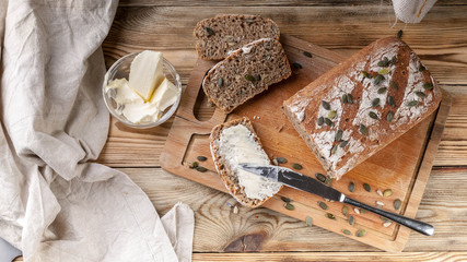 Homemade rye bread with pumpkin seeds and butter. Breakfast concept. Top view
