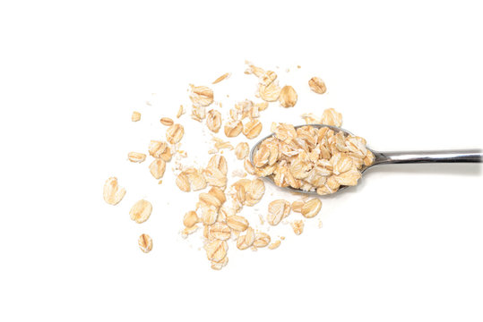Dry rolled oatmeal on white background - isolated