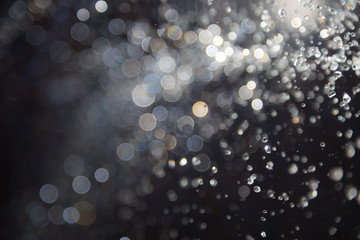 bokeh of water fly and lights on black background,