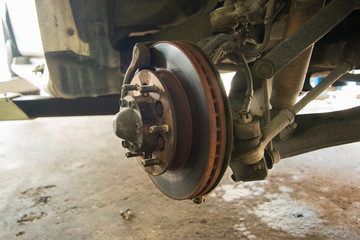 Repairing disc brake of the mini-truck in the garage