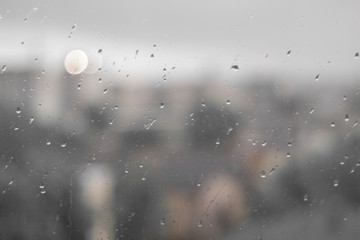 drops of rain on the glass in the background road