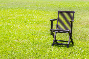 Black wooden chairs on the lawn.