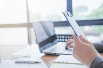 Administrator business man financial inspector and secretary making report, calculating or checking balance.