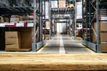 Desk of free space for your product and background of werehouse 