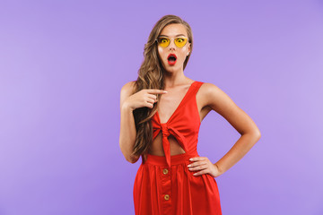 Portrait of a shocked young woman in red dress