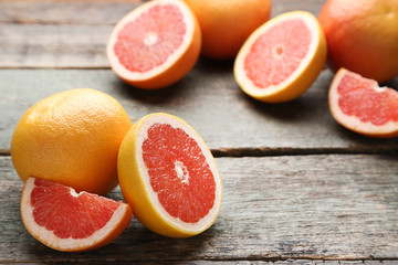 Ripe grapefruits on grey wooden table