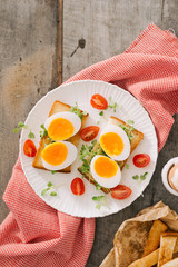 freshly boiled white egg on wooden board. Healthy fitness breakfast.