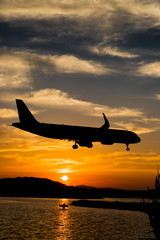 Fototapeta na wymiar Aeroplane landing during sunset